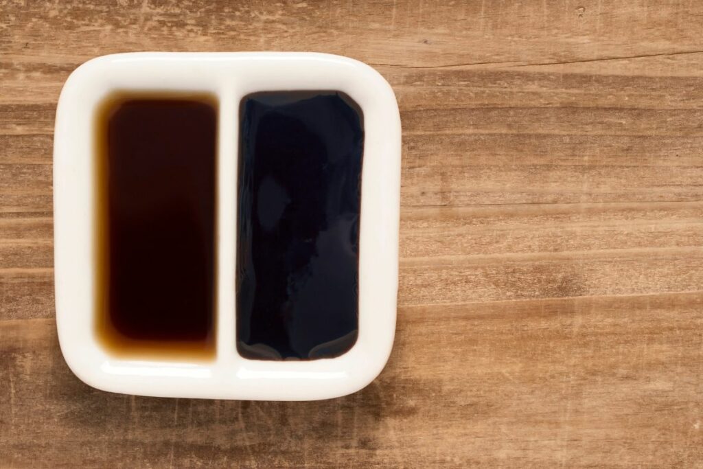 A sauce dish with light and dark soy sauce.