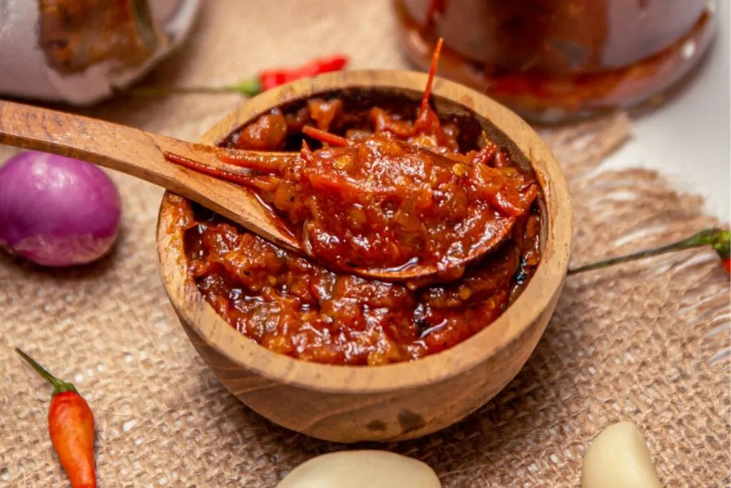 A bowl of sambal oelek made from tomatoes, chili, and garlic.