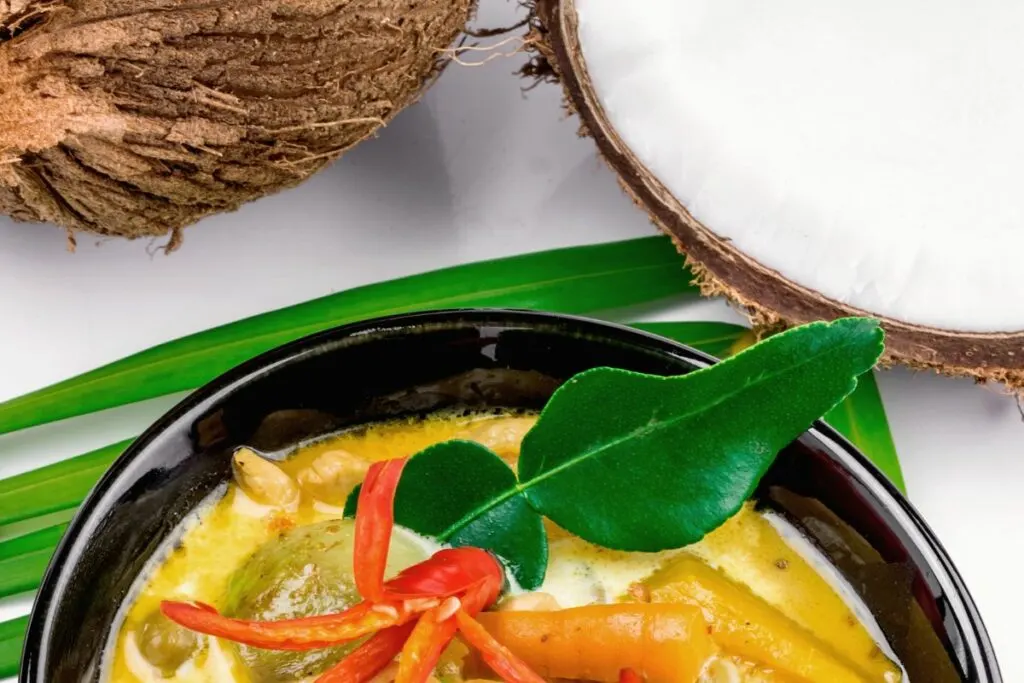 A bowl of tasty coconut curry soup made with coconut milk.