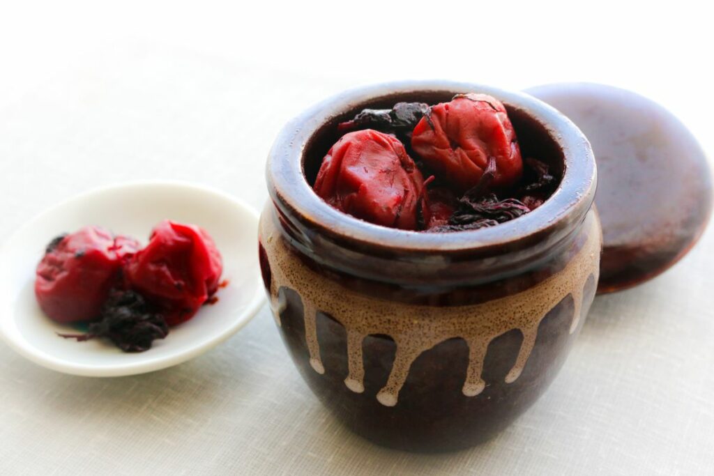 A pot of umeboshi with plums added to the top.