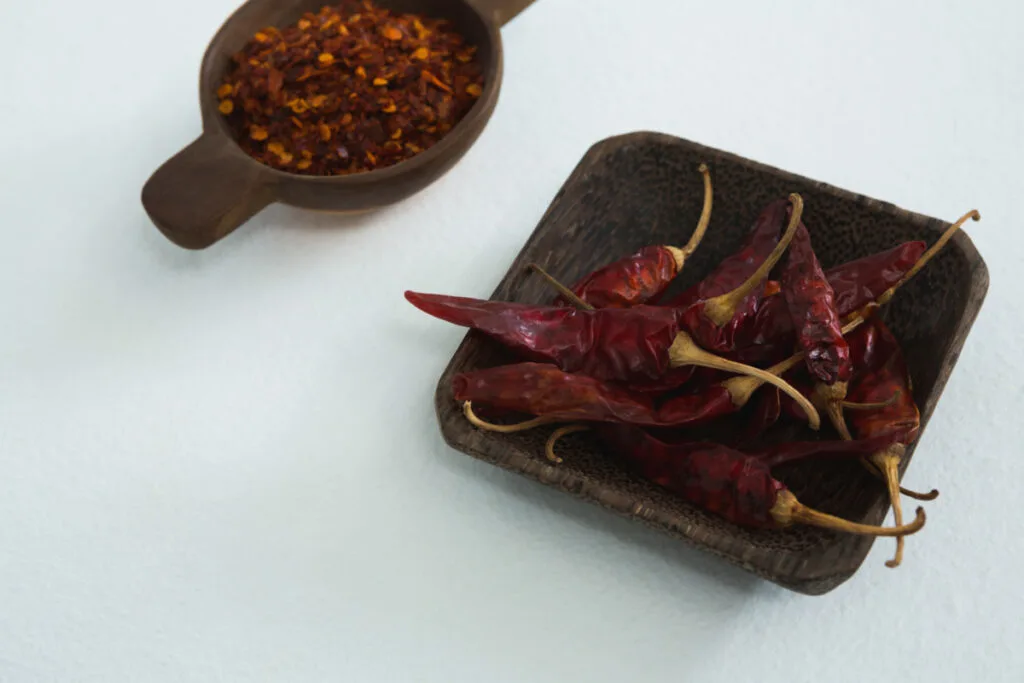 A black bowl of dried red chili peppers.