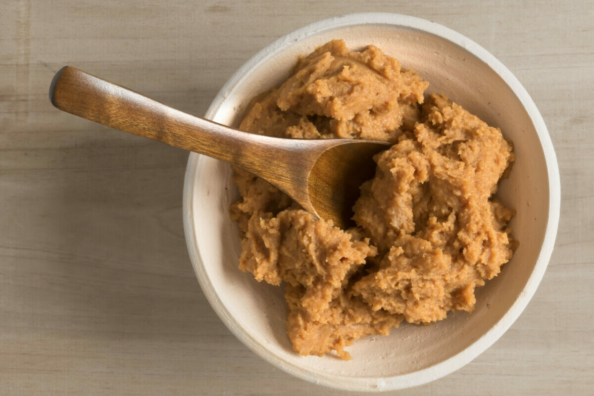 A tasty bowl of Japanese miso paste with a wooden spoon.