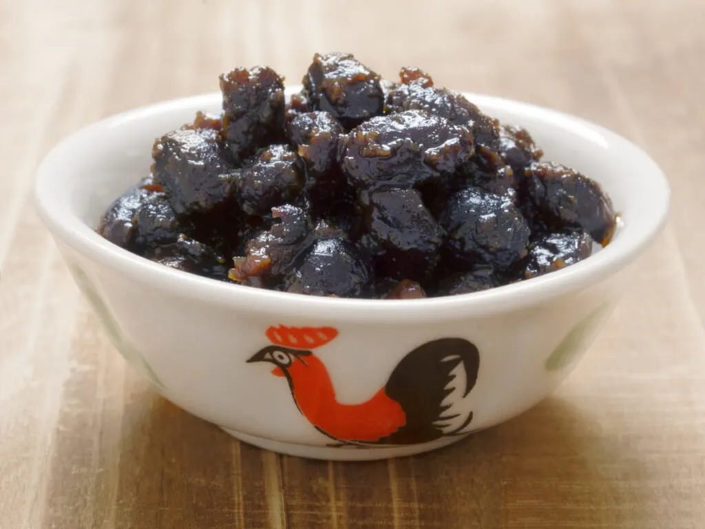 A tasty bowl of black beans in sauce.