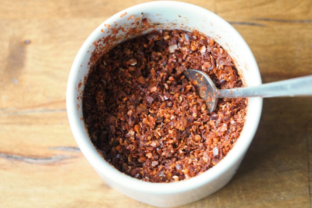 A bowl of spicy red chili flakes.