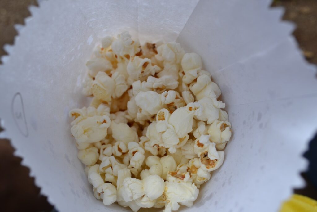 A bag of crispy popcorn taken from a movie theater.