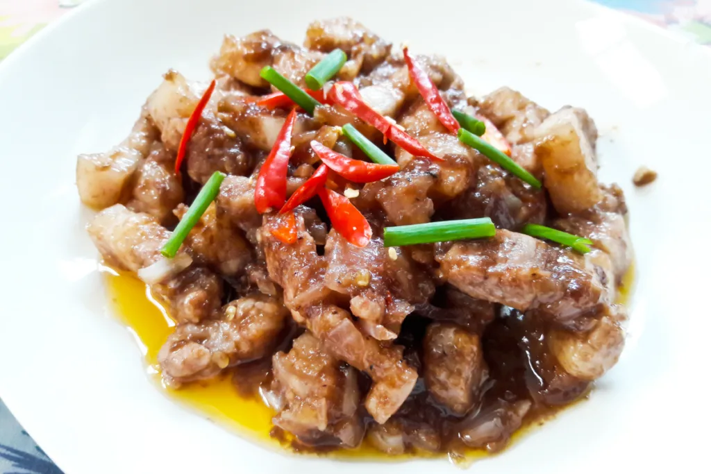 A plate of spicy pork pieces made with shrimp paste.