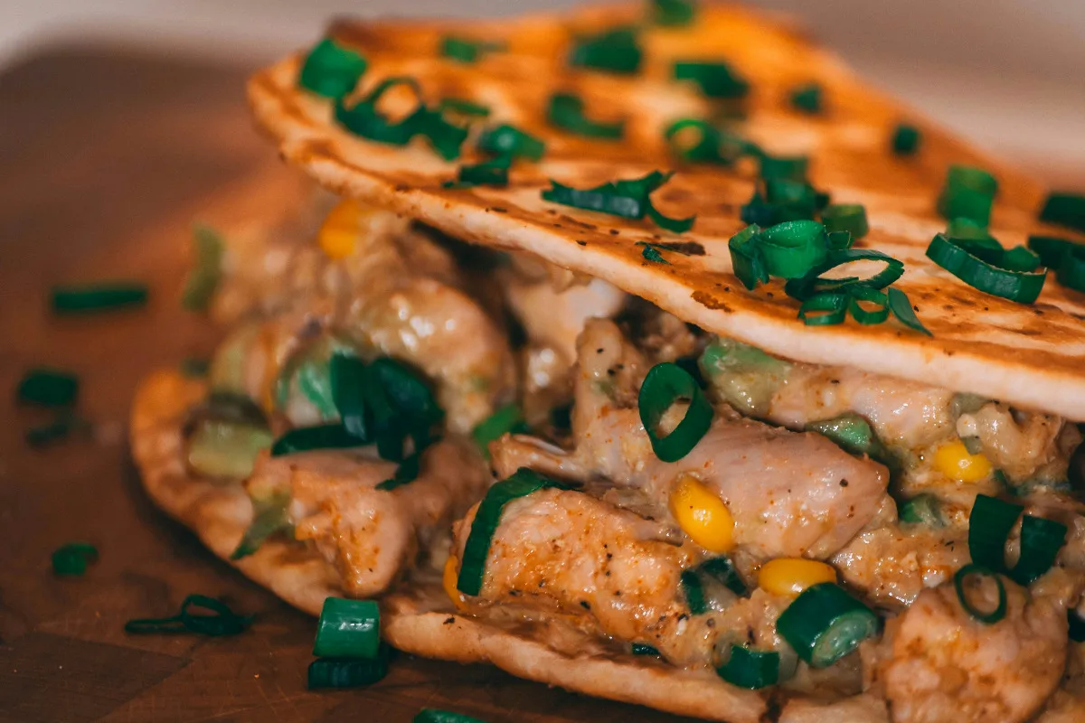 Taco Bell spicy ranch sauced chicken taco on wooden board.
