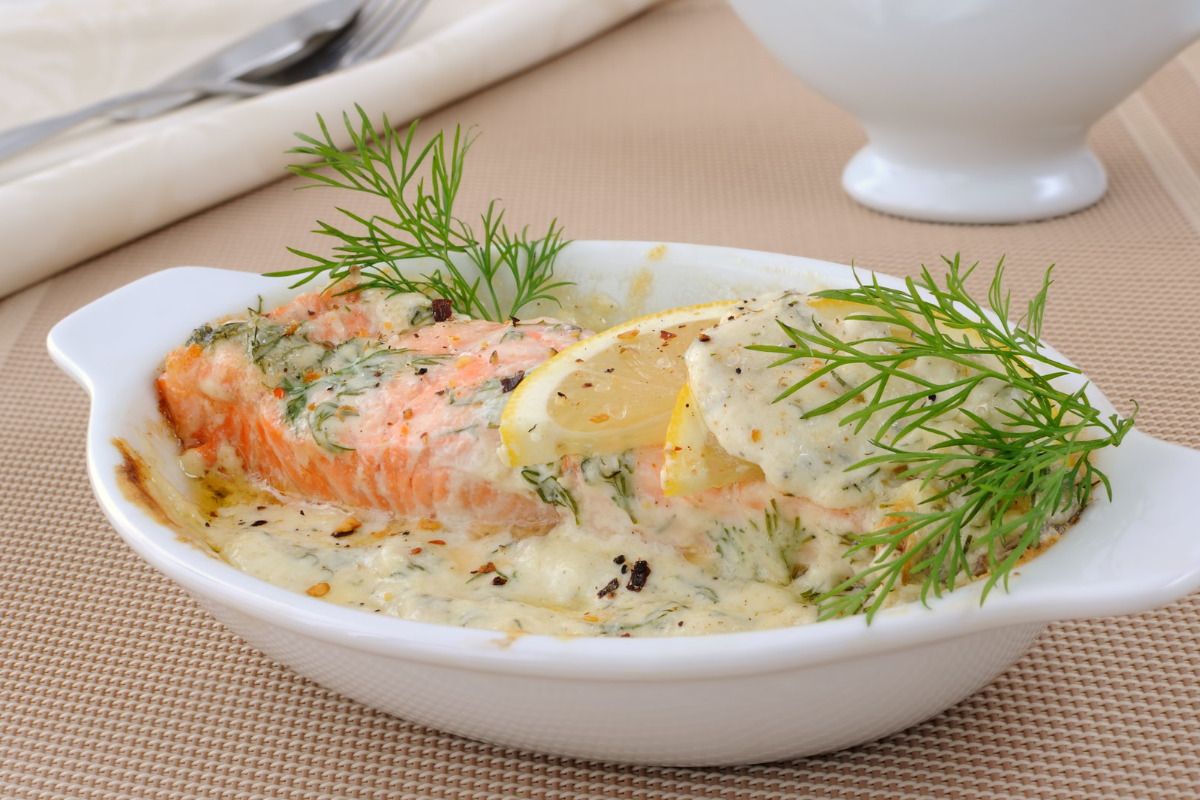 A delicious bowl of salmon with cream and lemon butter sauce.