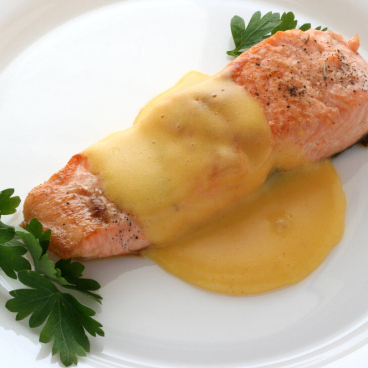 Seared Salmon on a plate with lemon butter sauce.