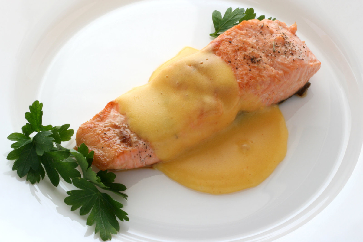 Seared Salmon on a plate with lemon butter sauce.