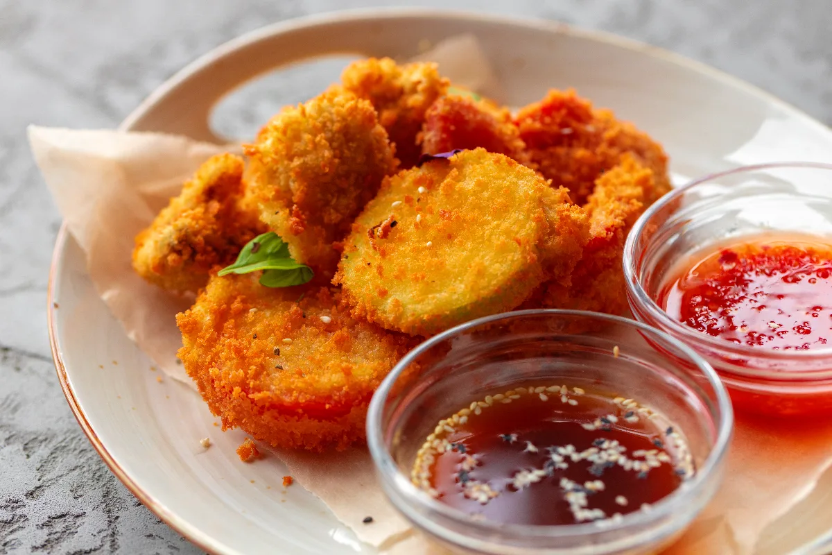 Chicken nuggets with a bowl of sweet chili sauce.