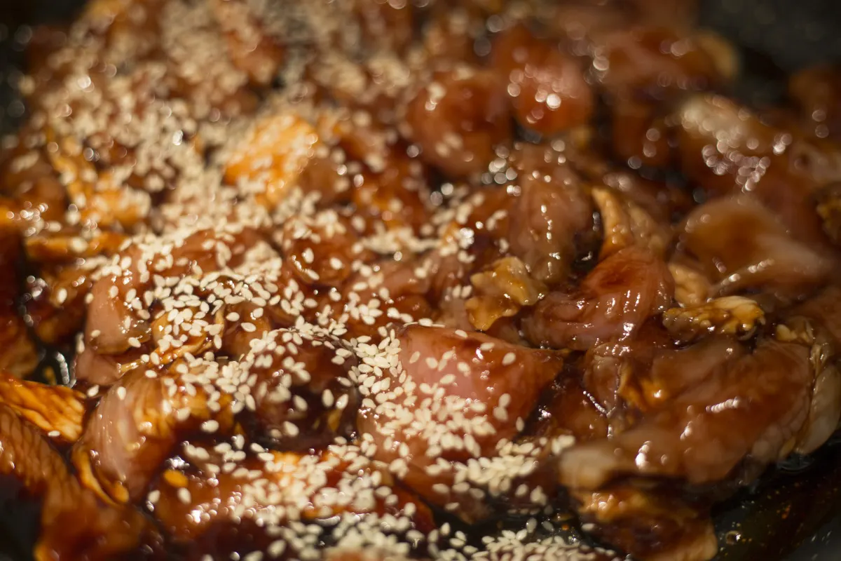 A tasty bowl of chicken teriyaki garnished with sesame seeds.