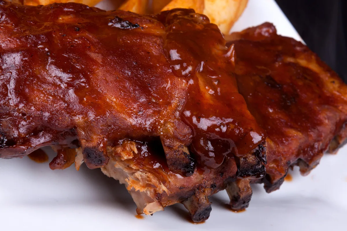 Rack of ribs coated in Texas Roadhouse's barbecue sauce.