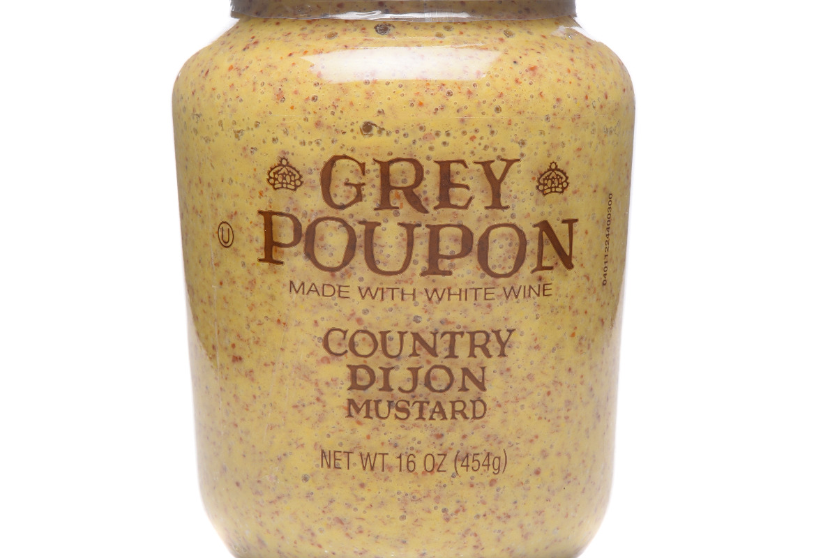 Gar of Grey Poupon Mustard Sauce.