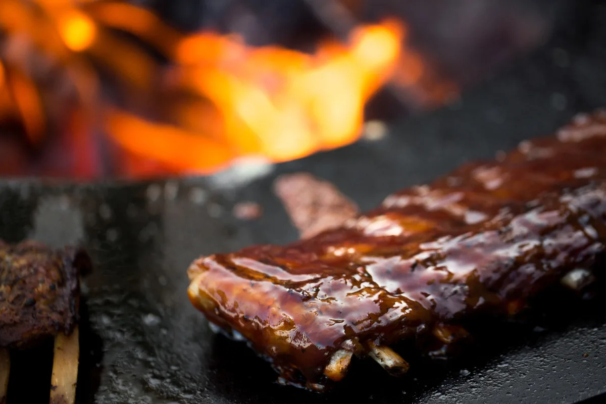 A stack of ribs being cooked on a stove.