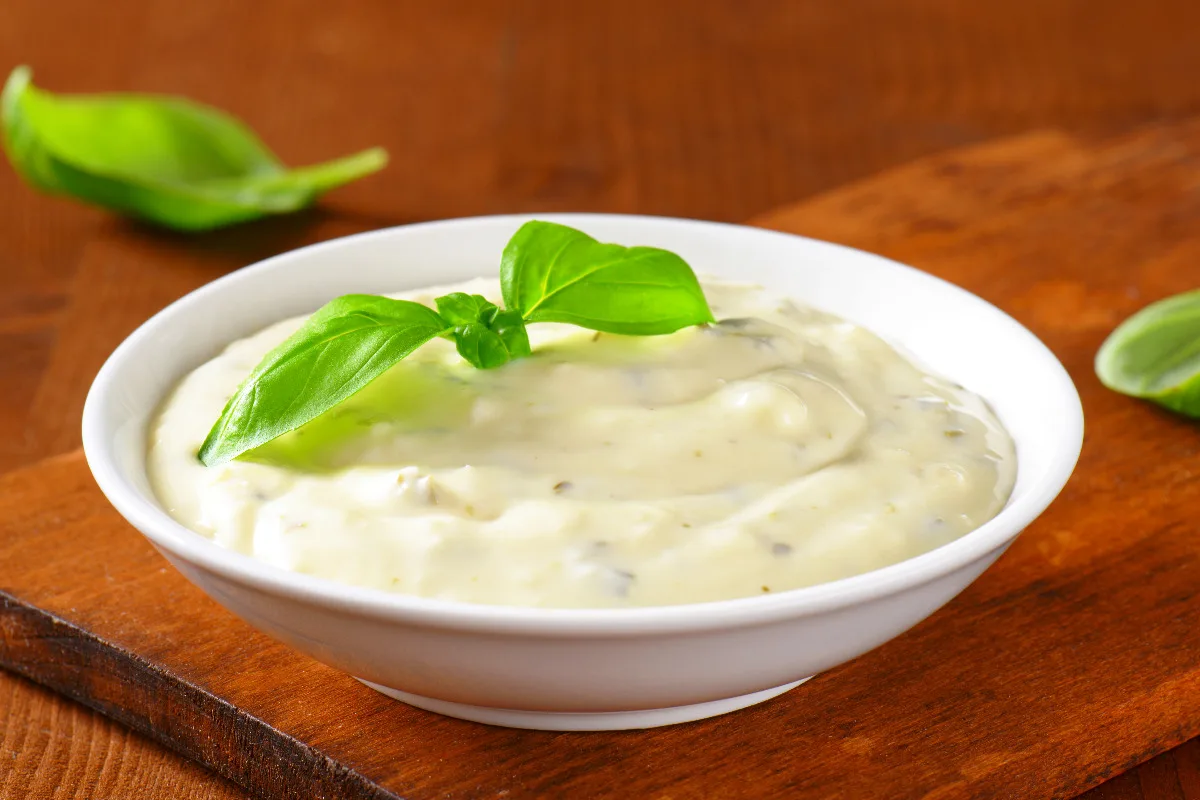 A sauce bowl of Little Caesars ranch sauce.